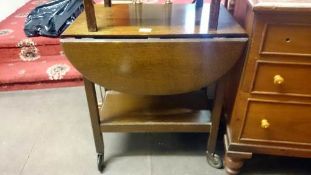 A 1930's oak drop leaf tea trolley