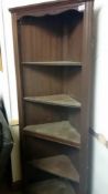 A dark wood corner cupboard