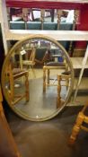 A large oval bevel edged mirror