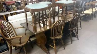 An oak pub style dining table & 6 wheel back chairs