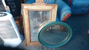 2 wooden framed mirrors