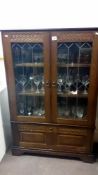 A 1950's oak display cabinet