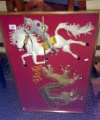A framed & glazed picture of a knight on a horse & a dragon