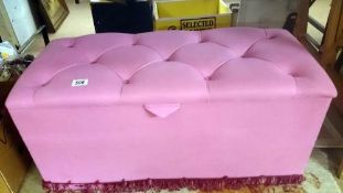 A pink Ottoman & contents