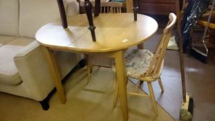 A small extending light wood table & 2 ercol style chairs