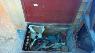 A wooden chest with tools etc.