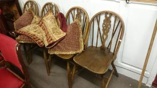 A set of 4 wheel back chairs