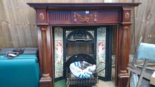 A mahogany fire surround with tiled inset & an electric coal effect fire