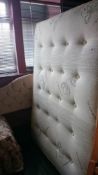 A double divan bed with mattress and head board