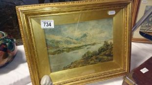 A framed and glazed watercolour mountain and lake scene