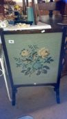 An oak fire screen with tapestry inset