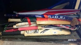 A quantity of hockey sticks, cricket bats etc