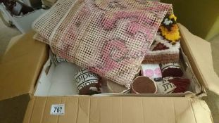 A box of rug making items