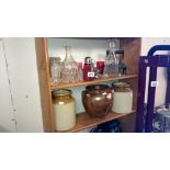 A mixed lot of glass, stoneware jars etc, 2 shelves