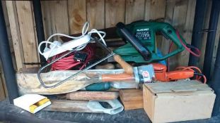 A shelf of garden & other tools