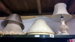 A table lamp and a quantity of lamp shades