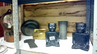 A shelf of miscellaneous including oil lamp