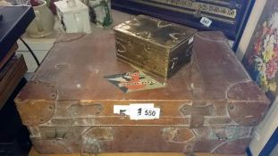 A vintage suitcase and a brass box