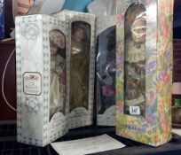 4 boxed porcelain dolls
