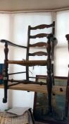 An oak ladder back elbow chair