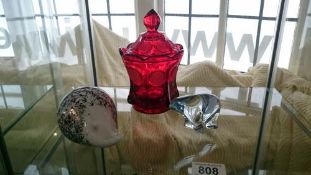 A ruby glass lidded pot, a Wedgwood hedgehog paperweight and a Norwegian glass bear