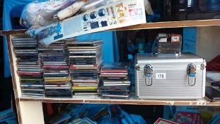 A CD rack, CD case & a large quantity of CD's