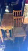 A drop leaf table and 2 chairs