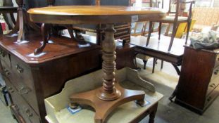 An oval pale mahogany table