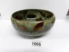 An Edwardian Royal Doulton stoneware bowl with leaves on a green glaze