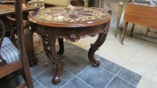 An Italian carved table with decorative marble top
