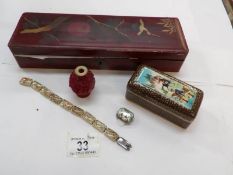 An oriental lacquered box and contents to include hand painted mother of pearl and silver brooch,