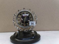 An unusual clock made in USSR with cut glass frame on bakelite stand with 11 jewels and in working