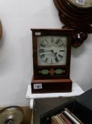 A postman's alarm clock with pendulum and key
