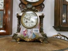 An unusual porcelain and metal mantel clock