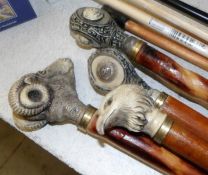 4 walking sticks including one with goat head handle and one with eagle head handle