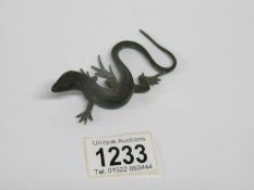 A patinated bronze lizard