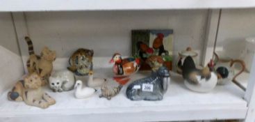 A shelf of mixed items including animal figures