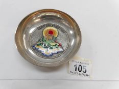 A white metal bowl with enamel decorations marked Croisieres Paquet with 'A Augis' on the bottom