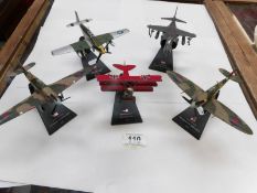 5 model aeroplanes on stands