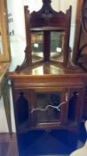 A mahogany corner cabinet