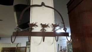 A wrought iron kitchen utensil rack