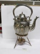 A silver plated kettle on stand