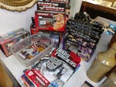 A quantity of Transformers collectibles including 7 boxed toys, 3 annuals and the complete works,