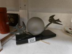 A 1930's French lamp with spelter swallows and marble base