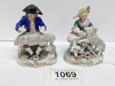 A pair of small continental porcelain figures,
