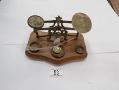 A set of brass and wood postal scales