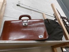 A vintage leather briefcase and a hat box