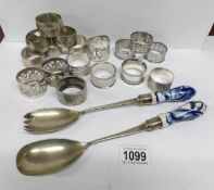 A mixed lot of napkin rings and a pair of salad servers