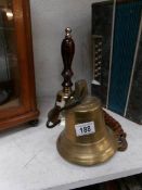 A brass hand bell and one other