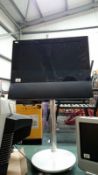 A Bang and Olufsen flat screen television on stand